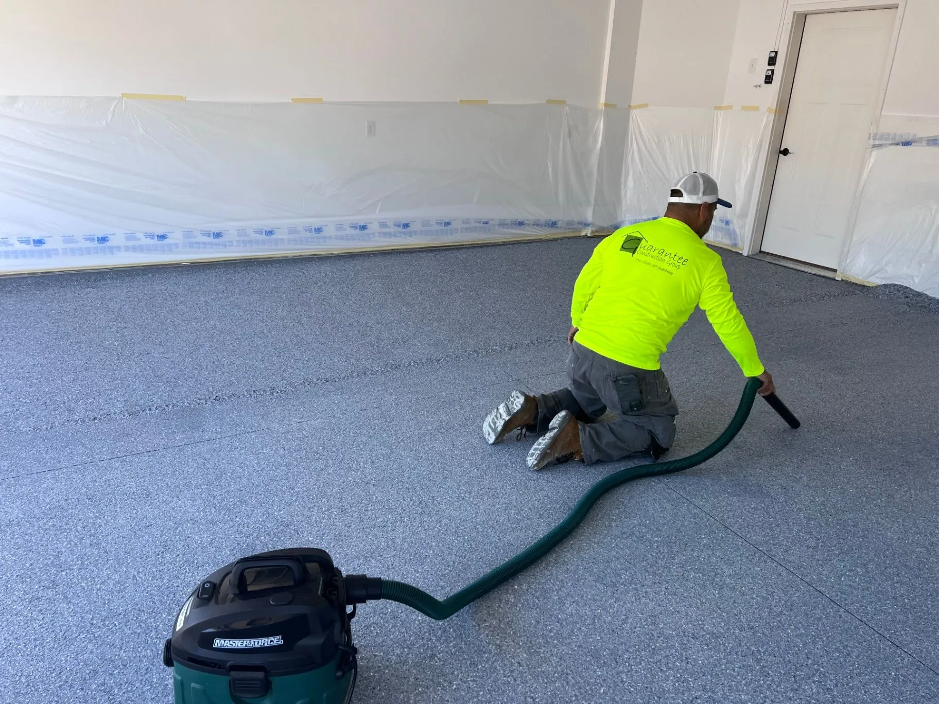 Crew member vacuuming a freshly installed flake epoxy floor in Blaine, MN