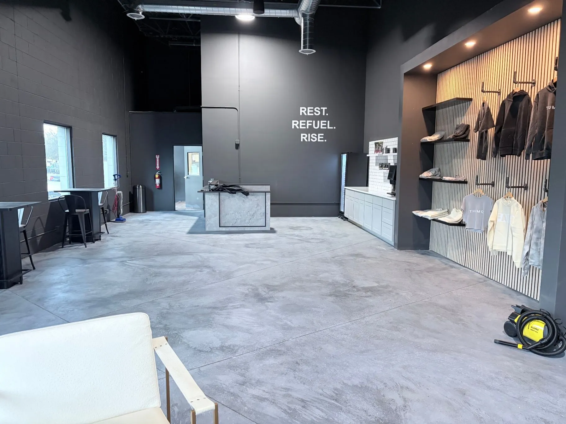Refinished concrete floor in a commercial gym in Blaine, MN, with apparel display and furniture back in place