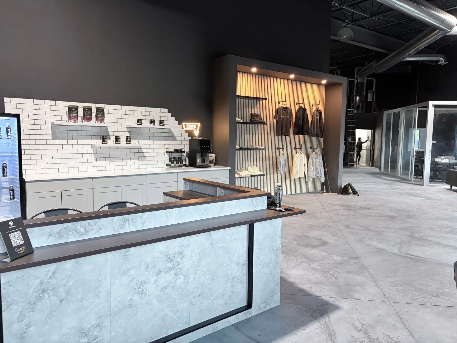 Finished concrete floor in a commercial gym in Blaine, MN, beneath the REST. REFUEL. RISE. wall