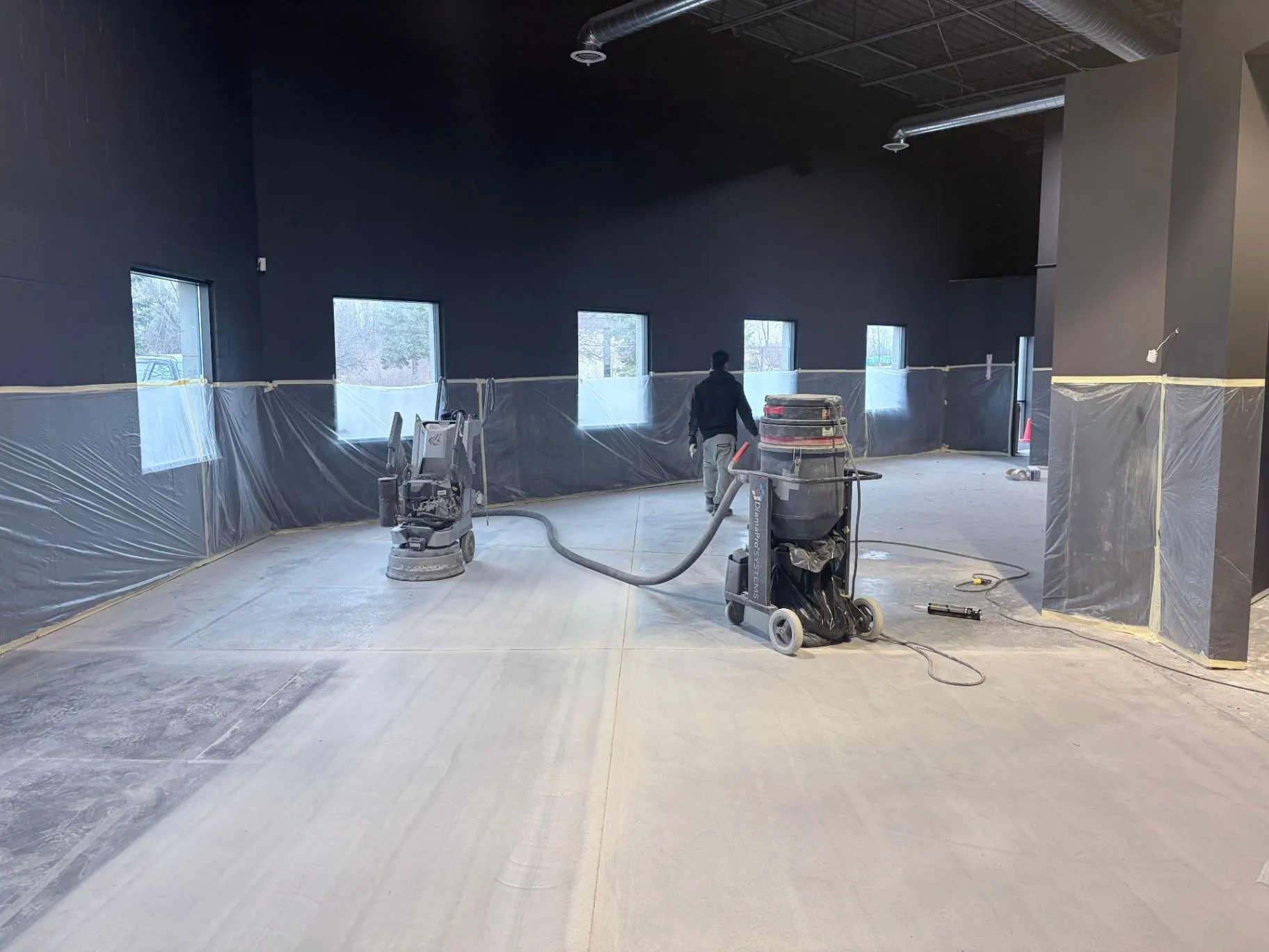 Concrete floor grinding and preparation with dust extraction in a commercial gym in Blaine, MN