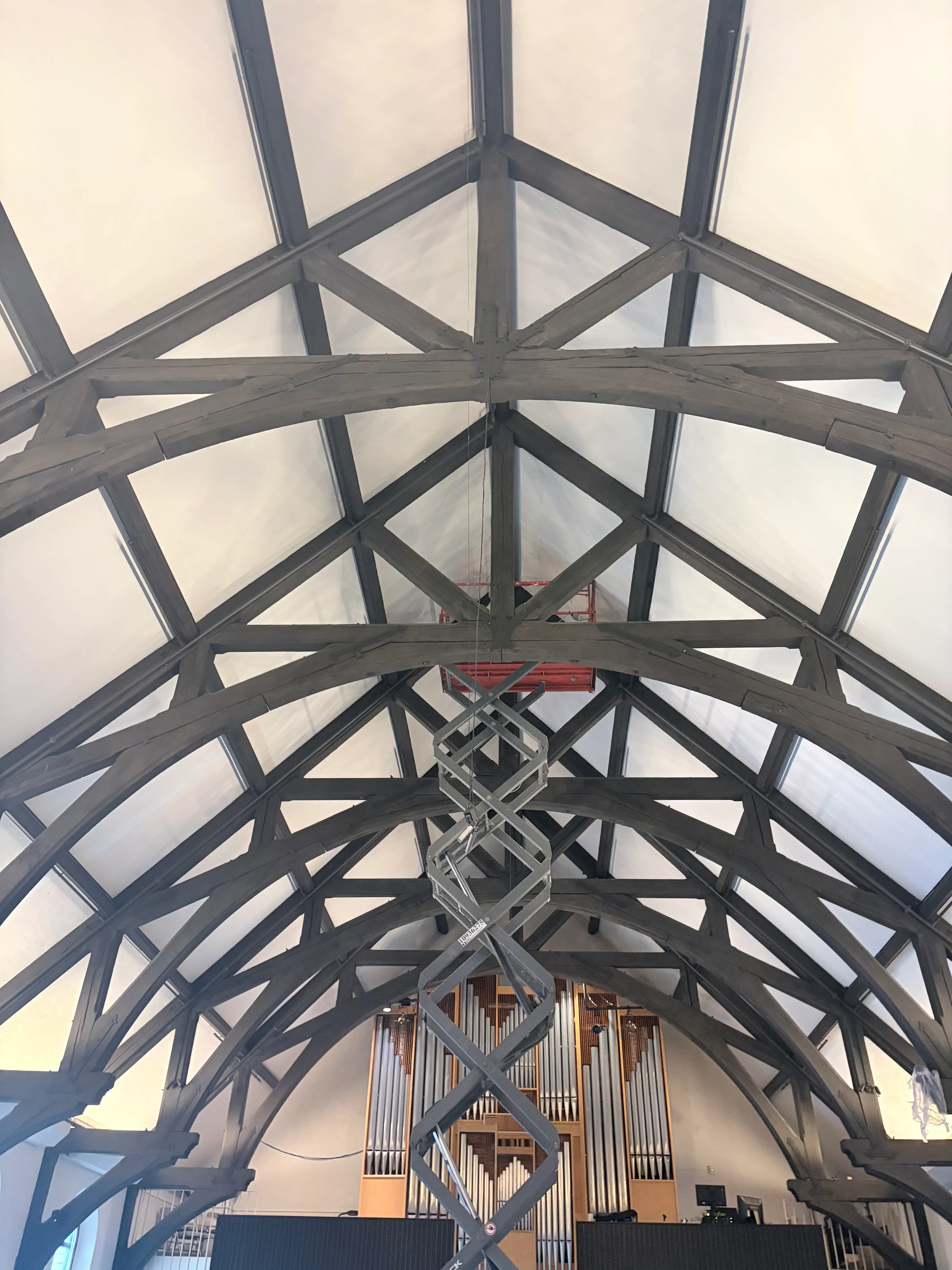 High church sanctuary trusses and lift access used for ceiling painting in St. Paul, MN