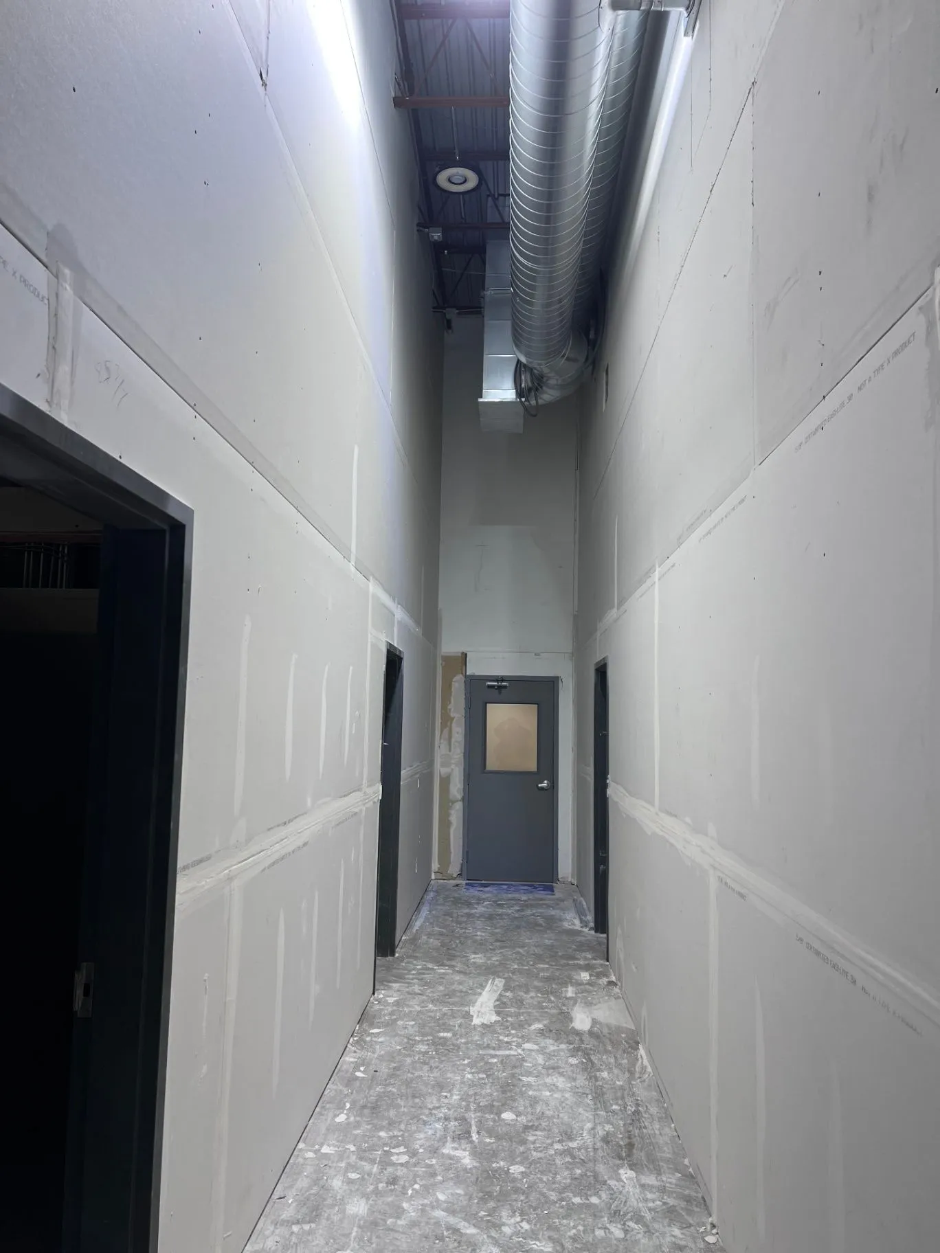 Drywall finishing work beneath high commercial ceilings in Eden Prairie, MN