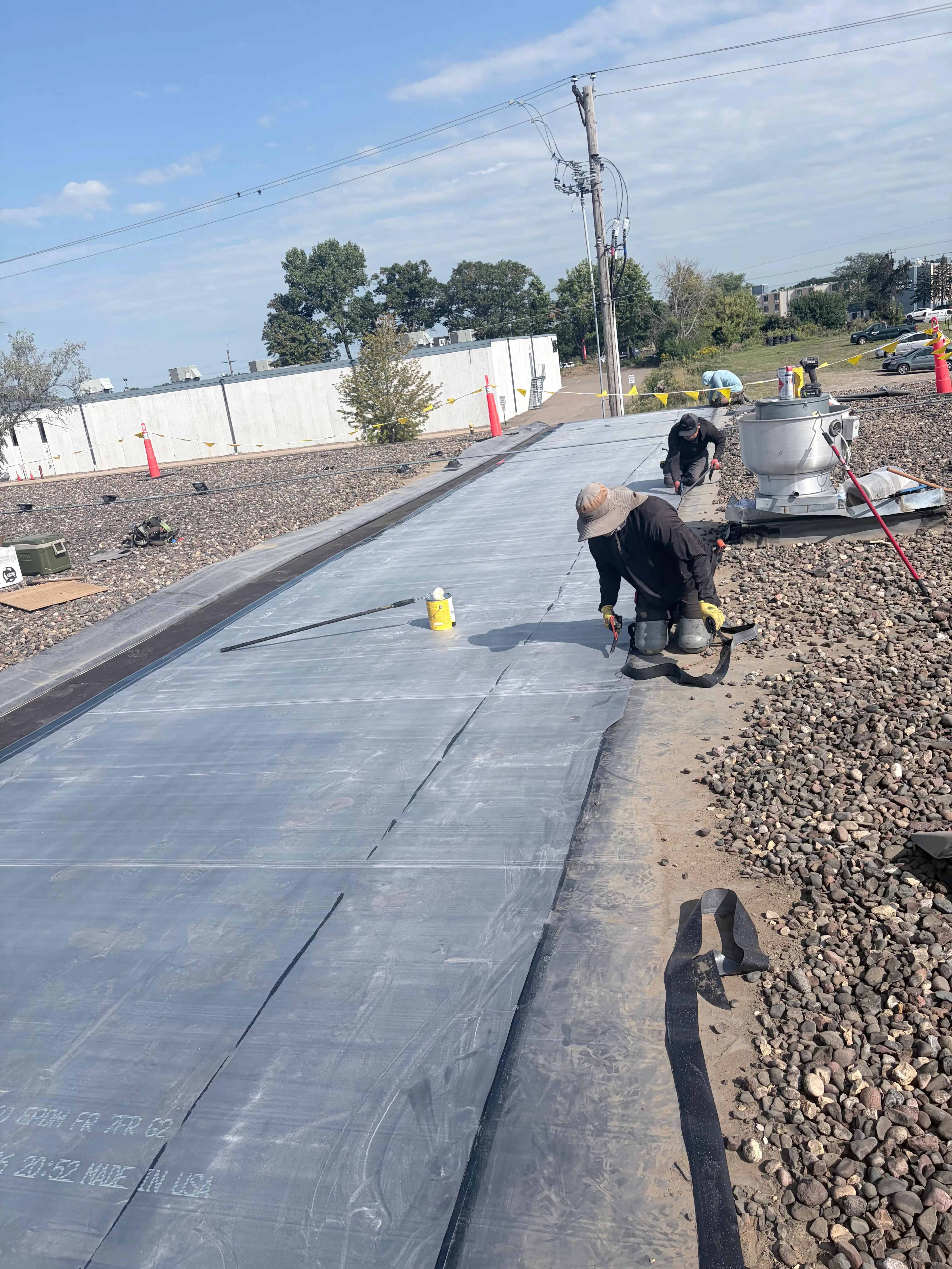 Crew from Guarantee Construction Group installing a new EPDM membrane on a commercial flat roof in Plymouth, MN