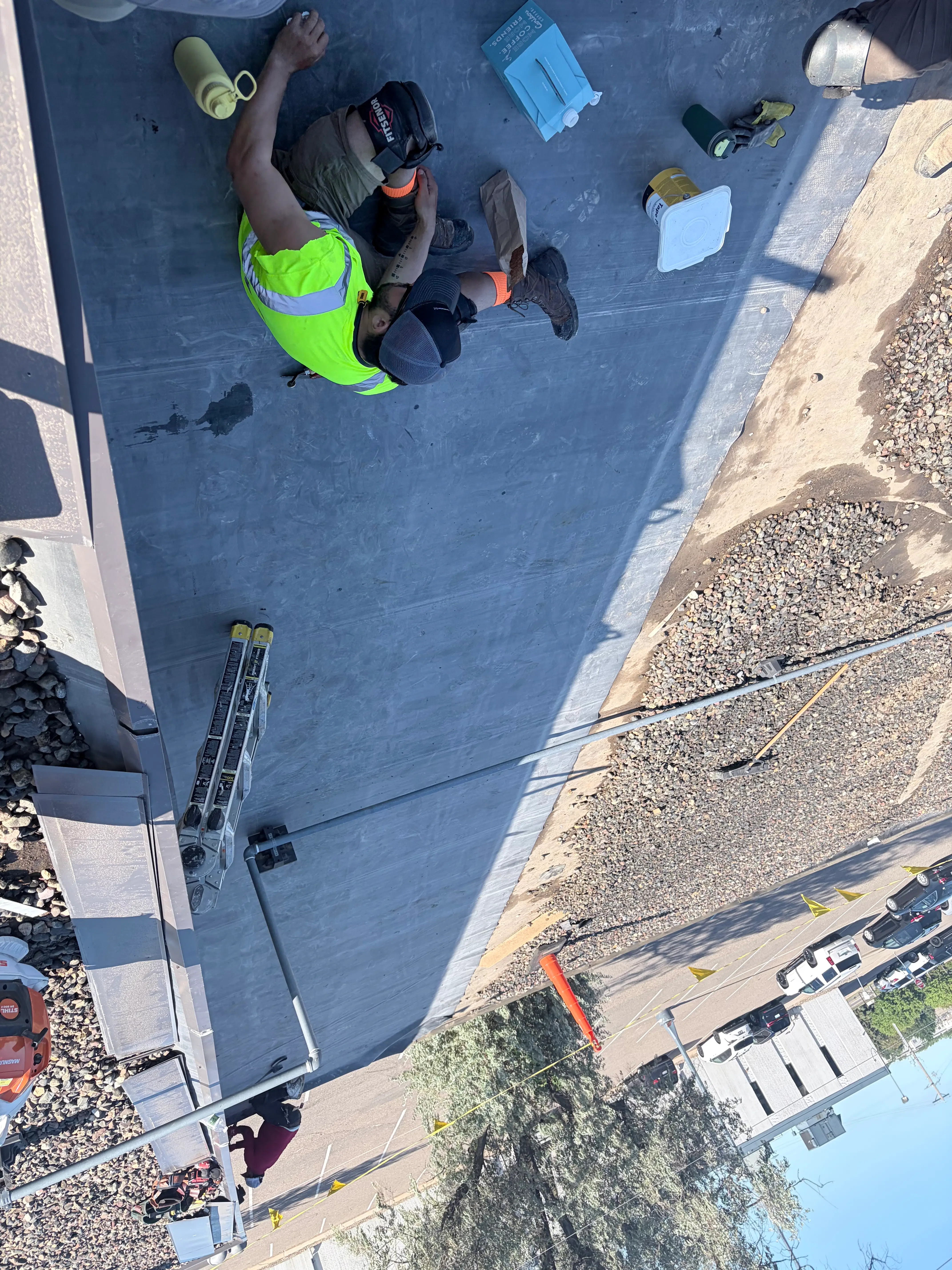 Crew member fastening a new EPDM membrane during a commercial flat roof replacement in Plymouth, MN