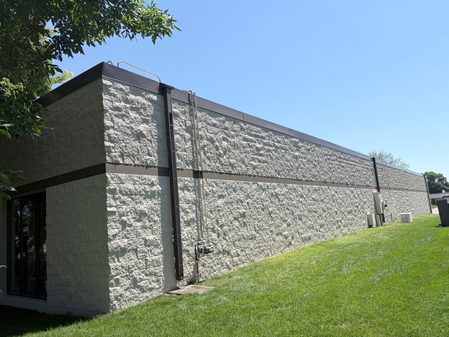 Freshly painted exterior block wall and dark roof line on a commercial building in Eagan, MN