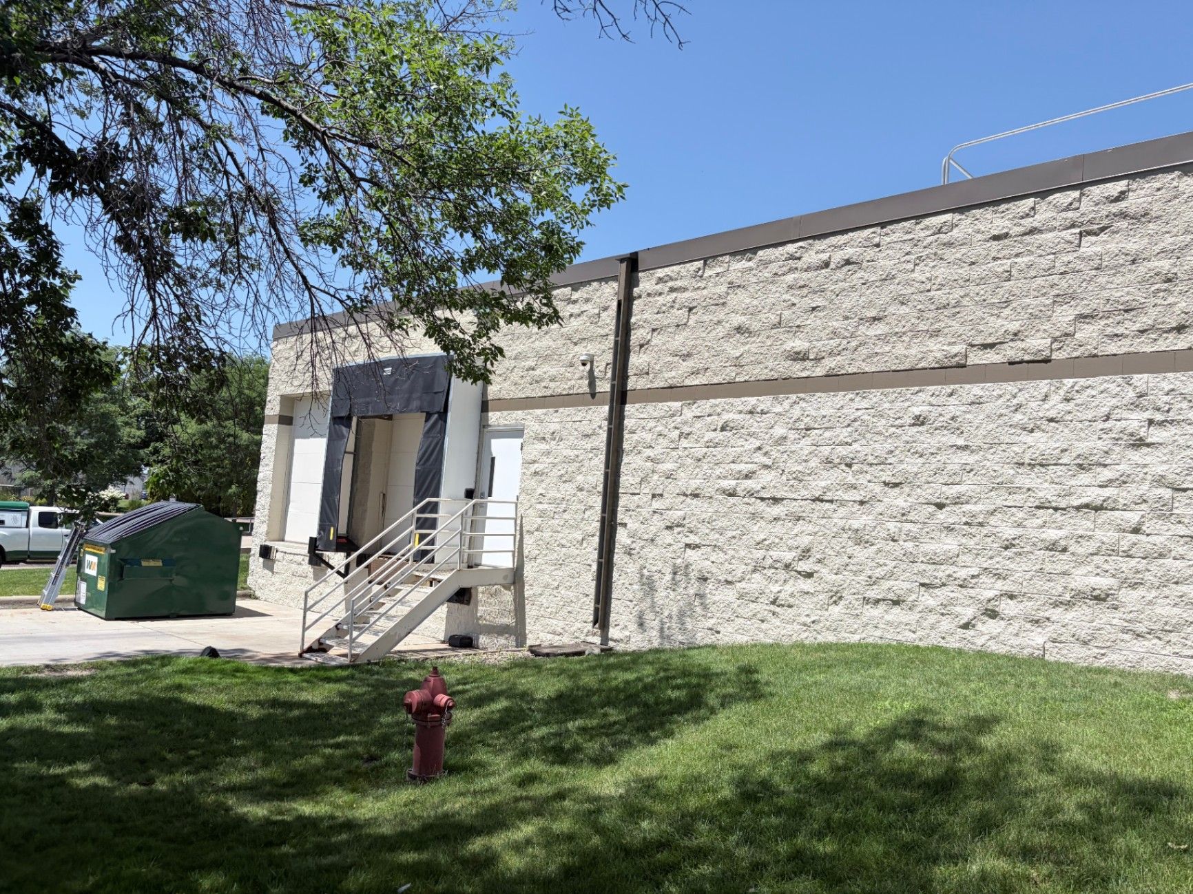 Protected entryway, walkway and dumpster on site during exterior painting at a commercial building in Eagan, MN