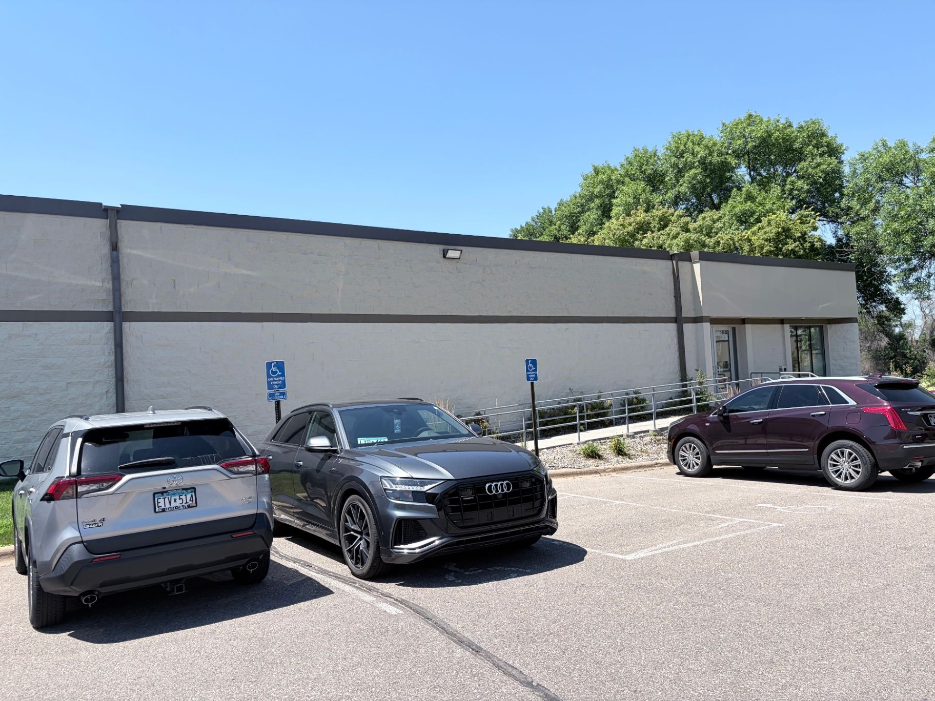 Finished painted exterior wall and accessible parking area at a commercial office building in Eagan, MN