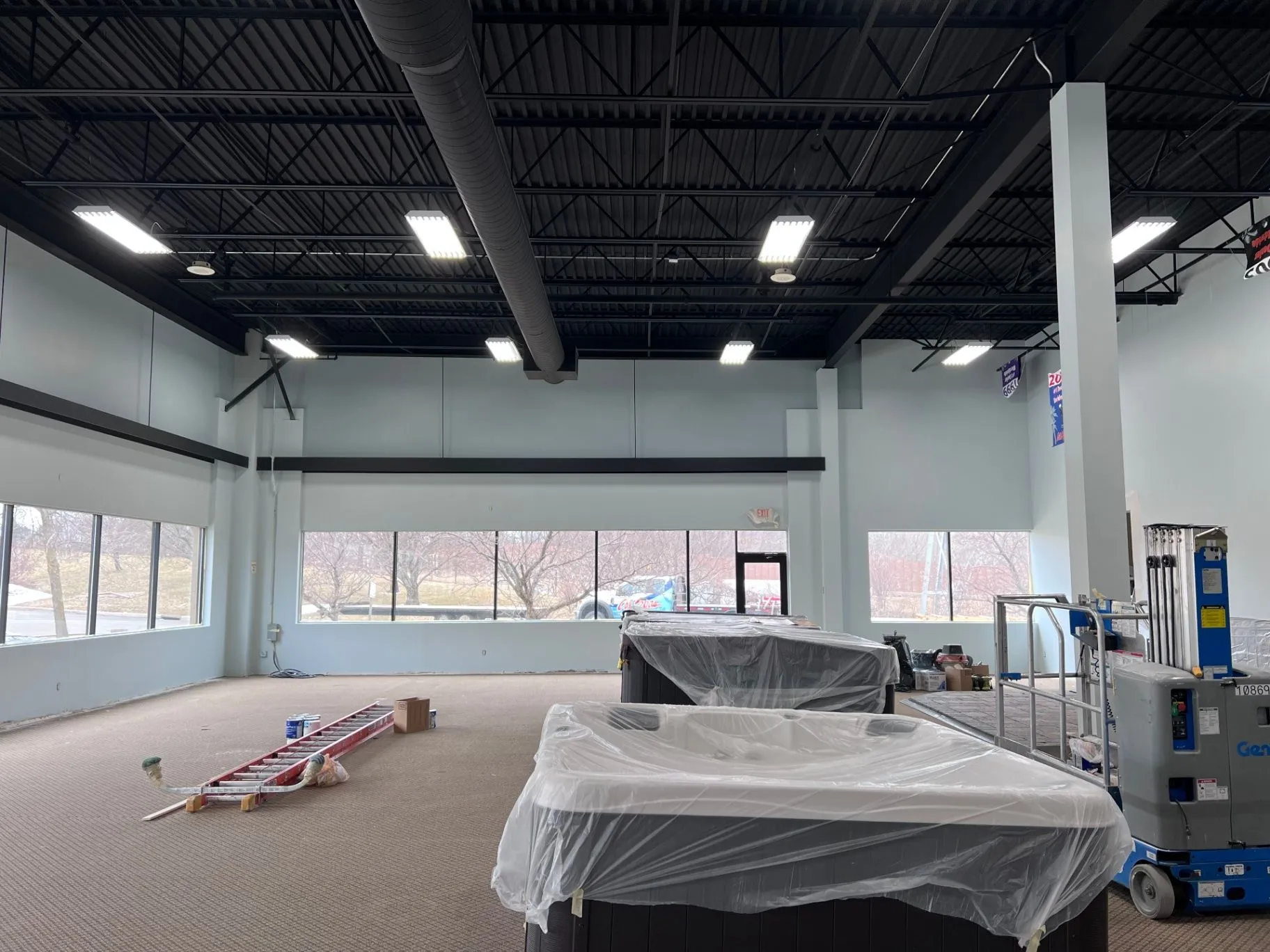 Commercial showroom painting underway around large front windows in Plymouth, MN