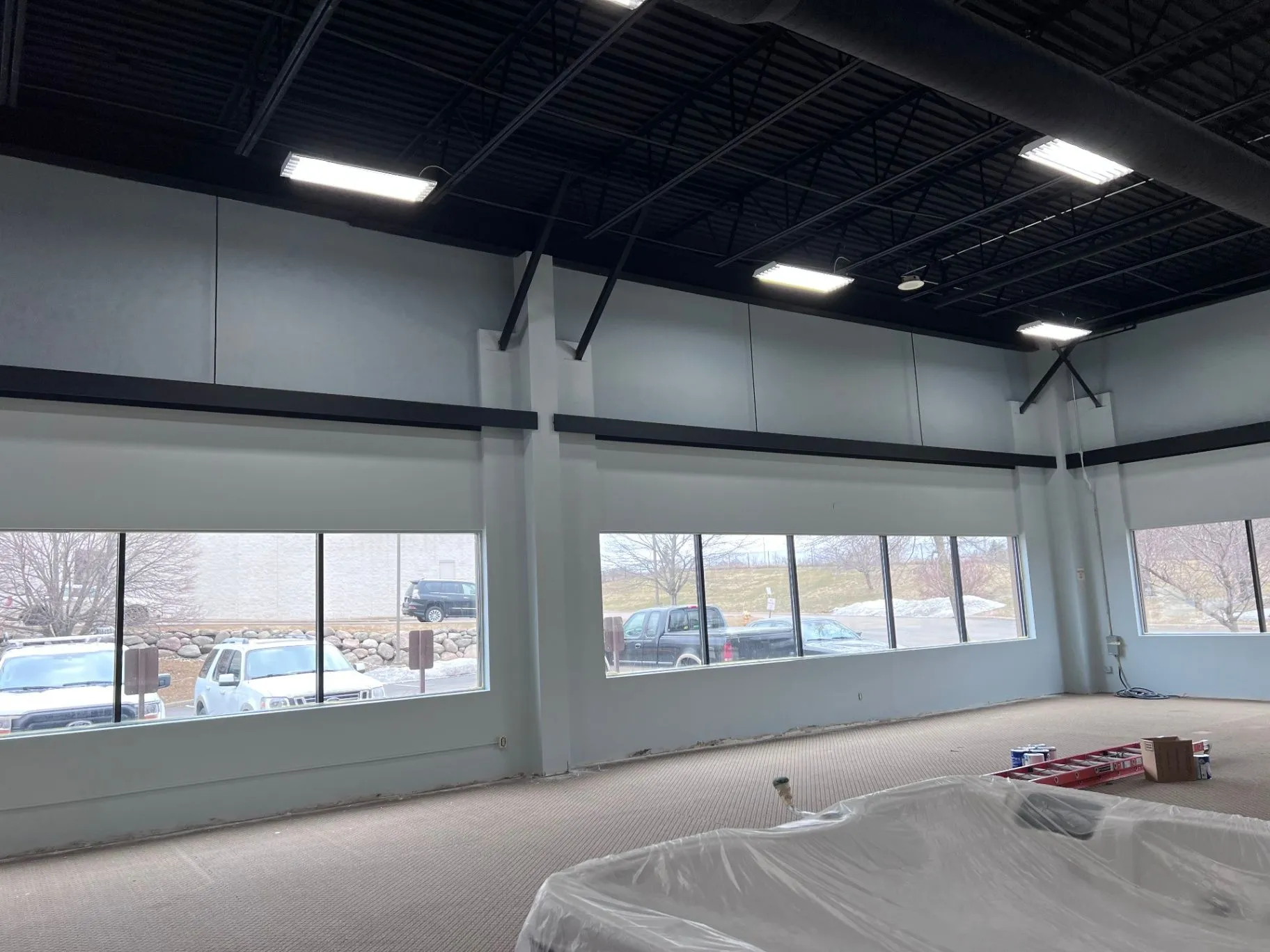 Interior painting work at the Cal Spas showroom in Plymouth, MN, with equipment and supplies on site