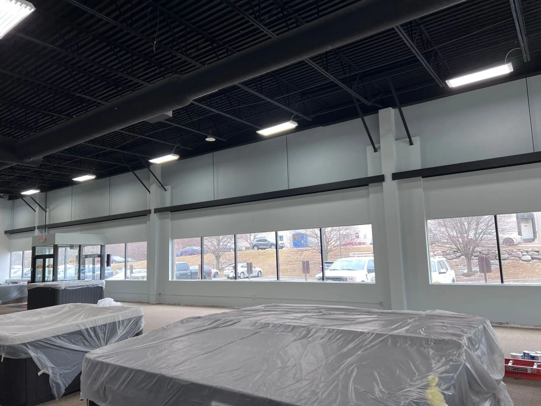 Painting work underway around showroom fixtures at Cal Spas in Plymouth, MN