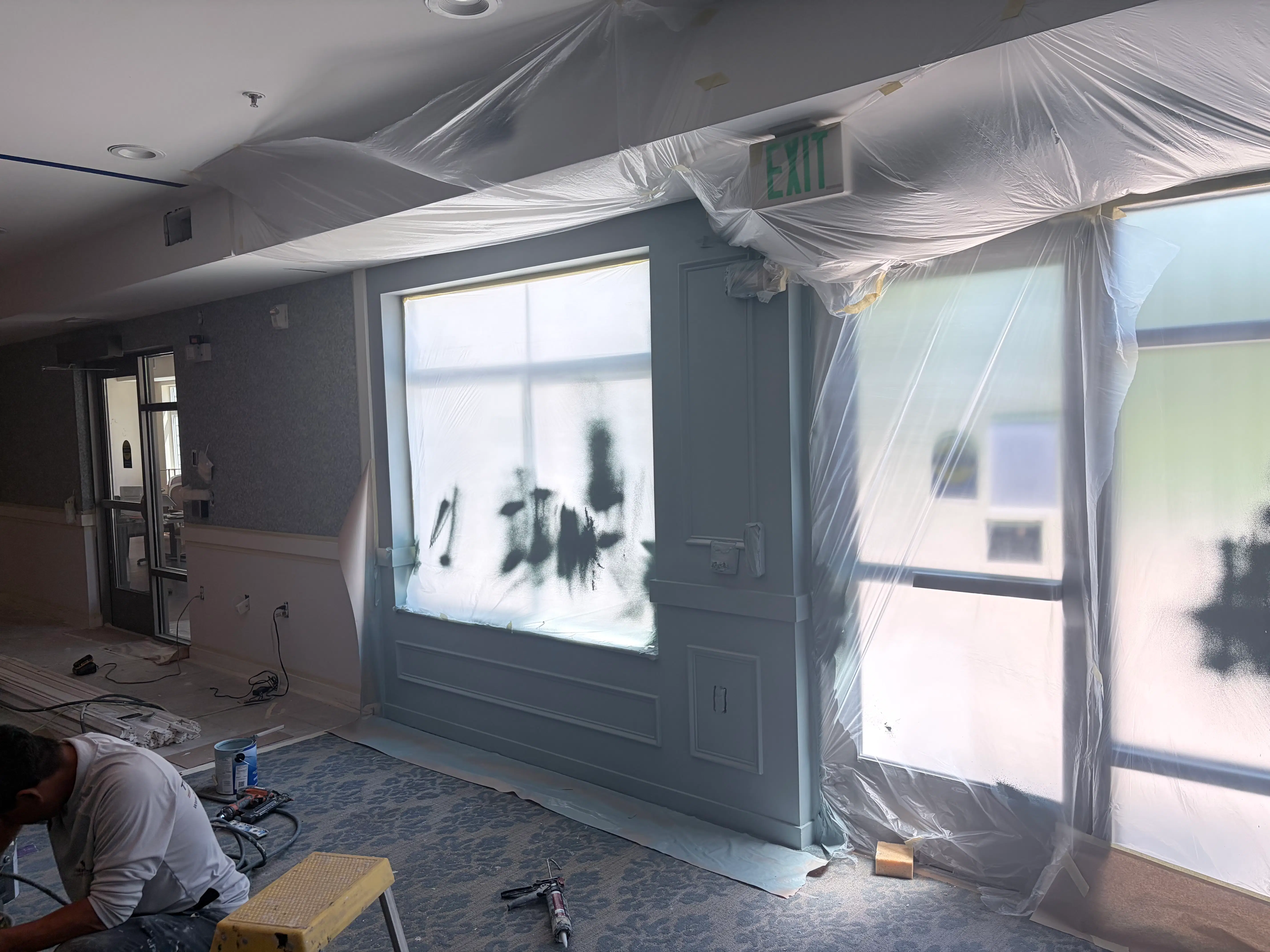 Trim carpenter installing new wood paneling and trim at The Waters of Edina senior living community in Edina, MN