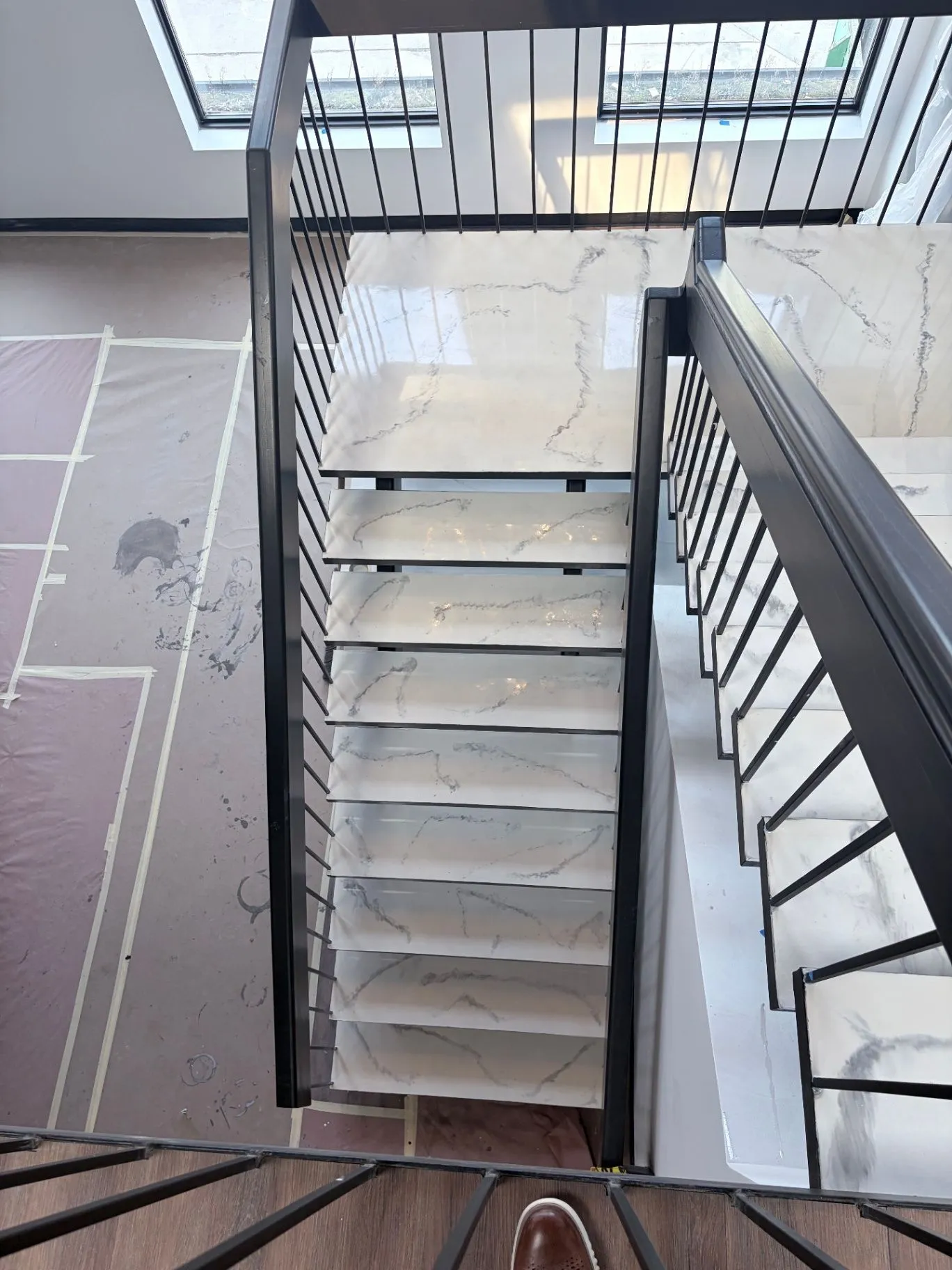 Epoxy coating on commercial stair treads with a black metal railing in Wayzata, MN