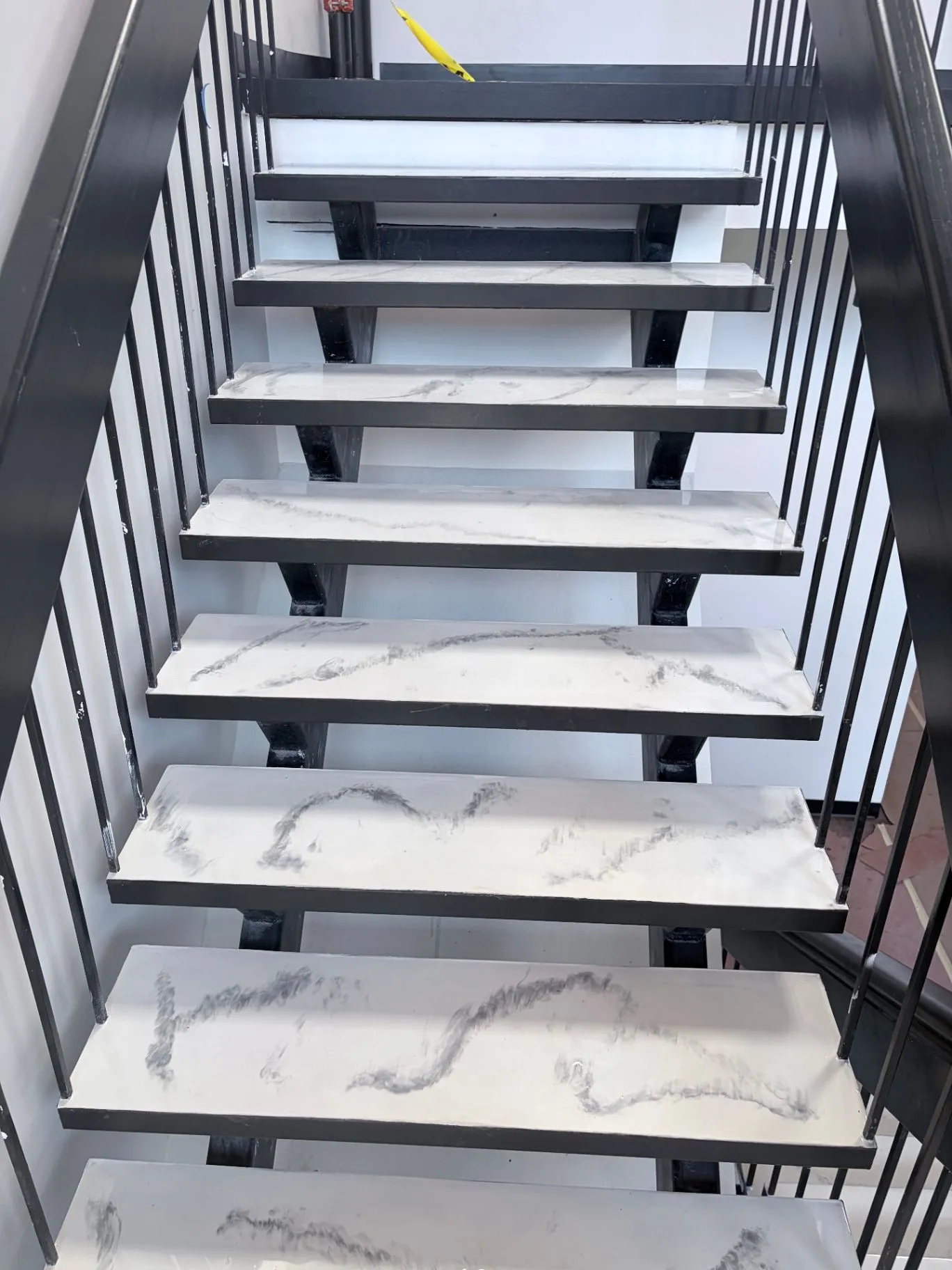 Floor protection and caution tape during commercial epoxy stair refinishing in Wayzata, MN